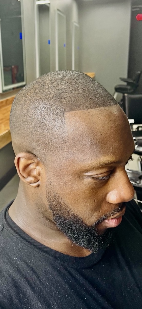 Skin fade and beard line-up, side profile, done at the studio