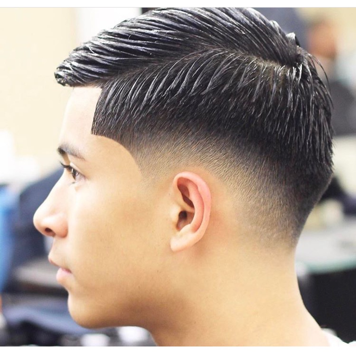 Modern comb-over taper fade styled clean and sharp